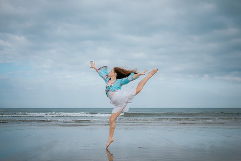 Image of girl dancing on the beach