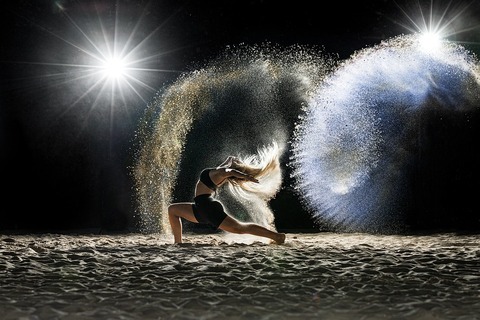 Image of girl dancing on the beach with sand